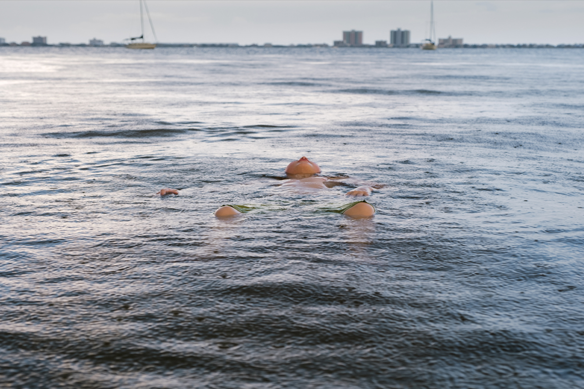 Boy floating in large body of water